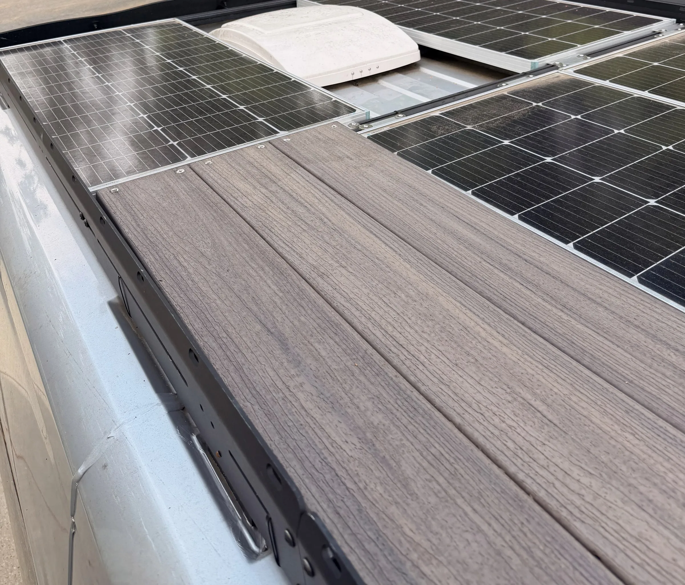 Composite roof deck beside the solar panels on top of the van