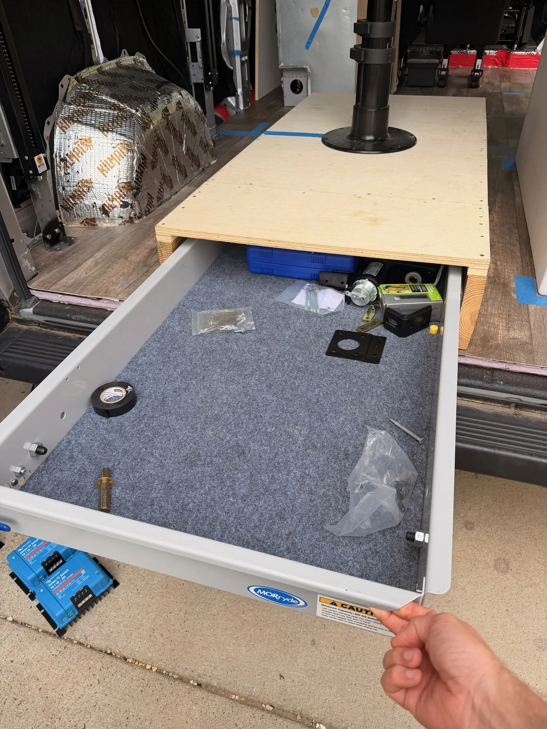 MORryde pull-out cargo drawer extended from under the rear plywood platform with carpeted tray